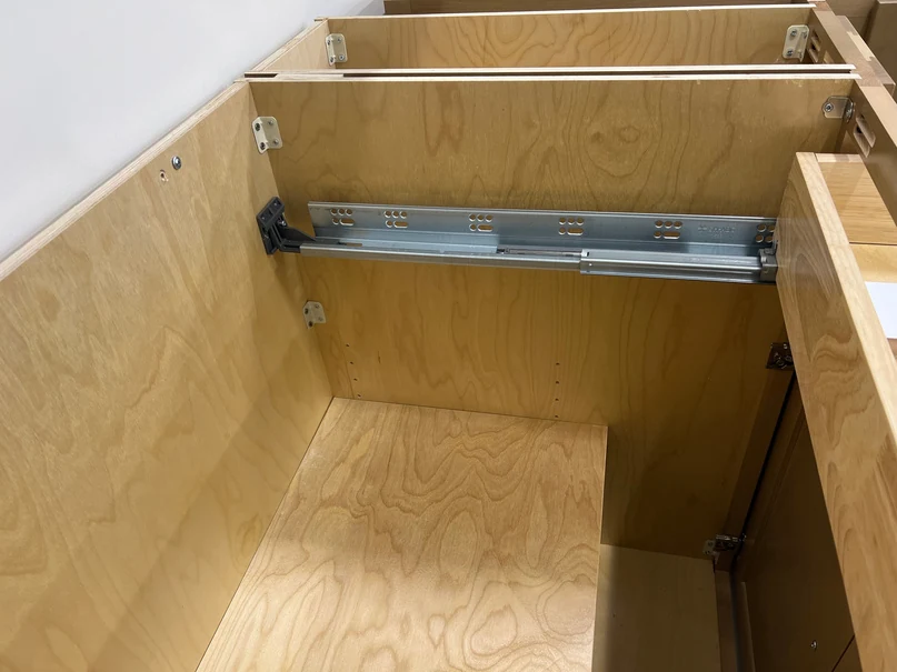 Highland cabinet interior with 1/2 inch plywood box, L-bracket reinforcement, and steel drawer glide