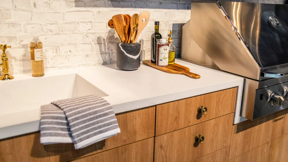 Palm Shade Caesarstone quartz with brass hardware