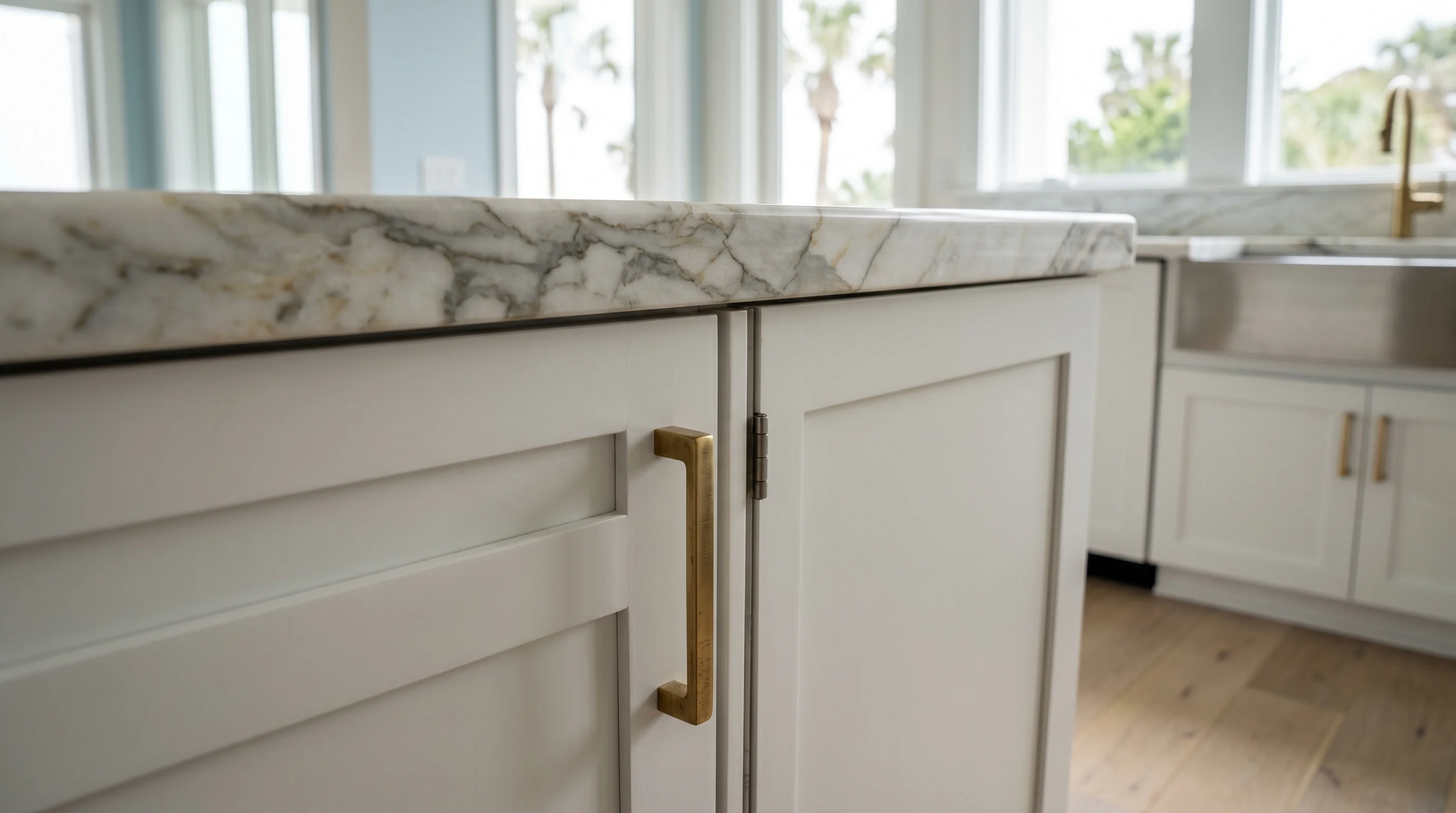 Delray Beach luxury kitchen with marble waterfall island and brass pendants