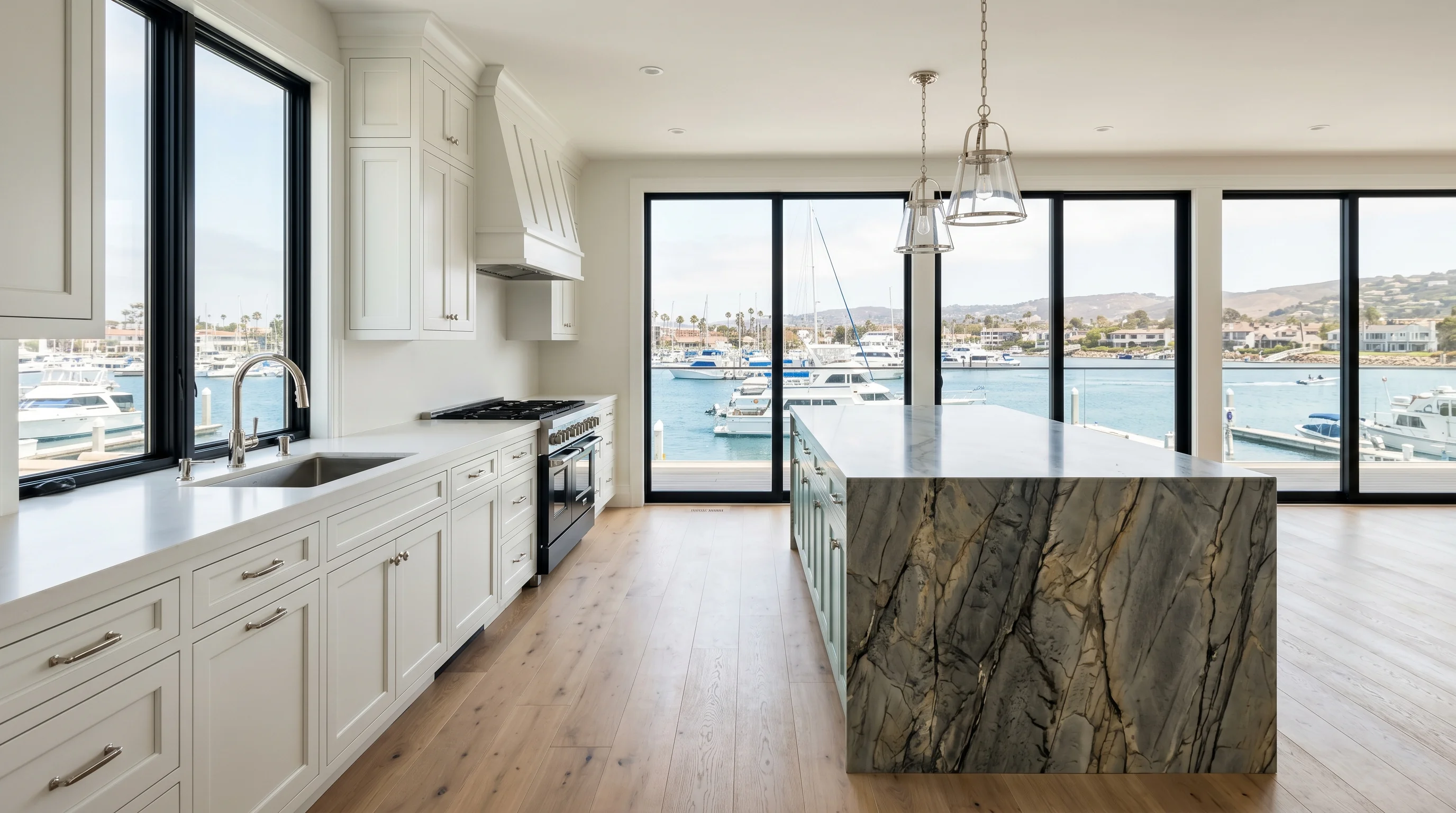Wide cinematic Jupiter kitchen with marble island and arched windows