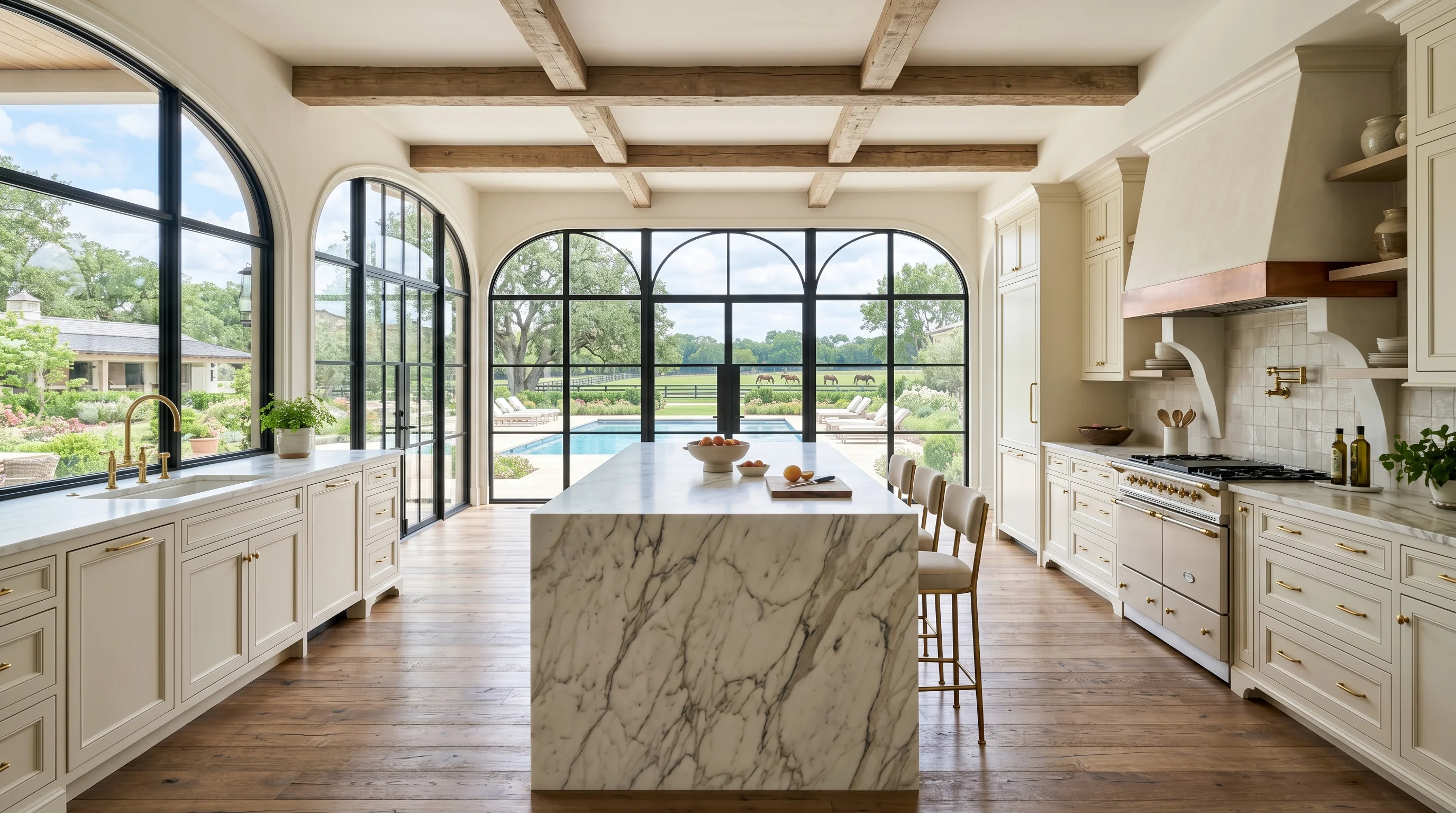 Ultra-wide Wellington kitchen with marble waterfall island and pool deck view