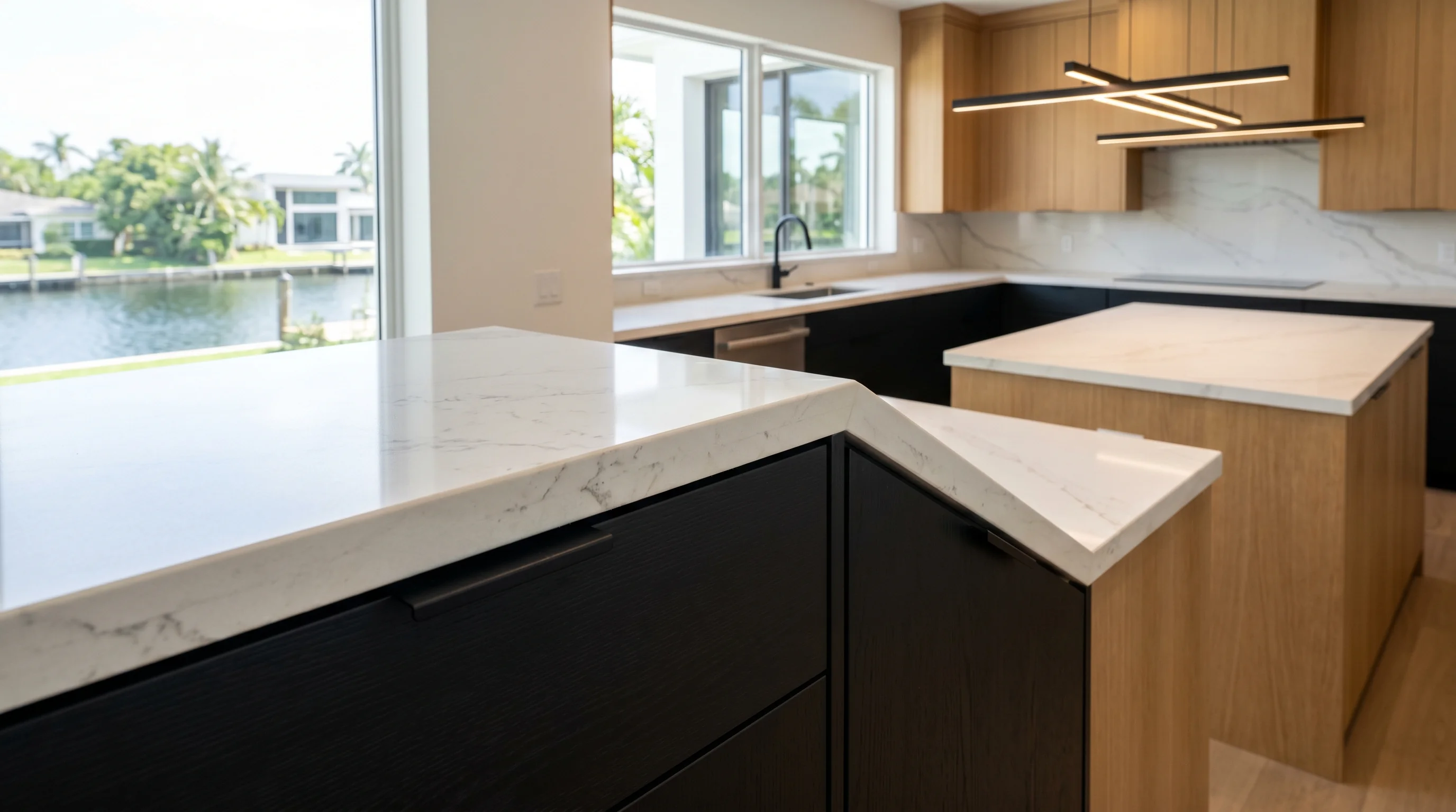 Westlake luxury kitchen with marble waterfall island and brass pendants