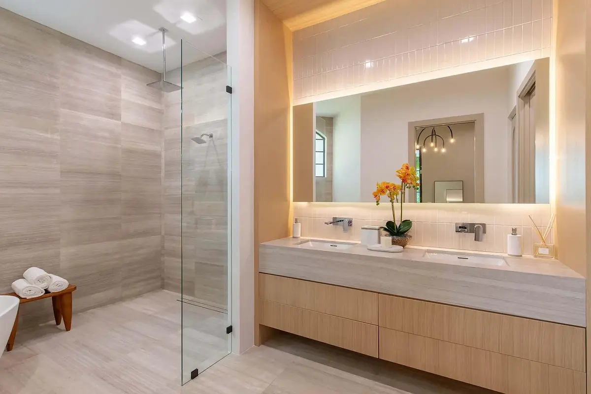 Luxury bathroom remodel with walk-in shower, floating vanity, and LED mirror in Palm Beach County by South Florida Kitchen and Bath Design
